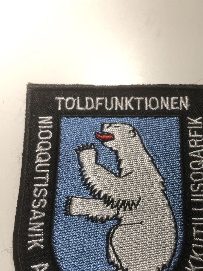 Tullen Grönland, broderat